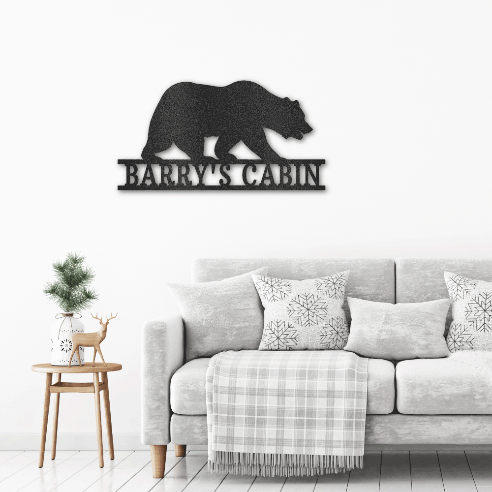 Metal Wall Sign from a walking bear with custom name or text underneath hanging on the wall above a couch
