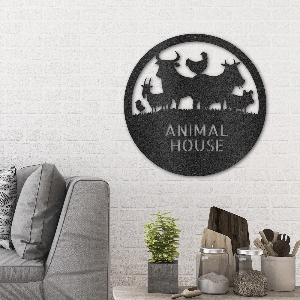 Metal wall art sign of farm animals, a chick , chicken, goat, cow, bull and a pig inside a circle. Personalize this design with your own name or text. Hang it on your wall as home decor. Available in the color black. Hanging on the wall in the living room above a couch.