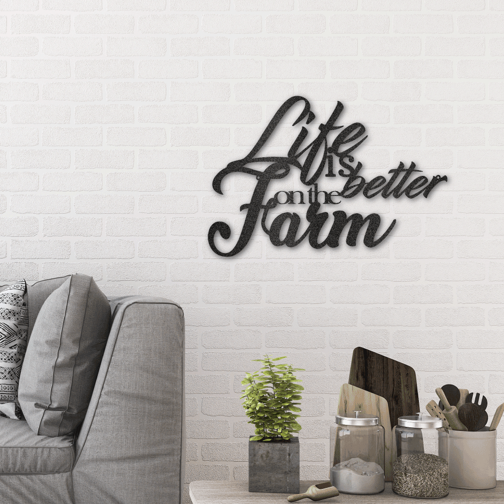 Metal wall art sign as a home decor for farm houses. It is the quote 'Life is better on the farm' . This picture shows the design in the color black. The sign is hanging in the living room above a couch.