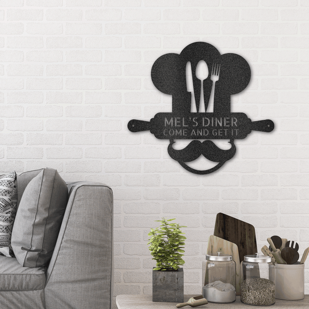 Metal Wall Art Sign of A Cooking chef with a chef's hat and a rolling pin that you can personalize with your own custom text or names. Hanging on the wall . It has the color black.