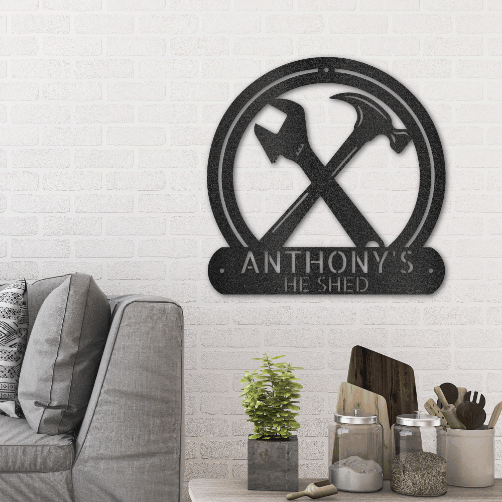 metal wall art sign for arts and craft people to hang in their workshop. This design shows a hammer and a wrench that you can personalize with a name or message. This picture shows the design in the color black hanging in the living room