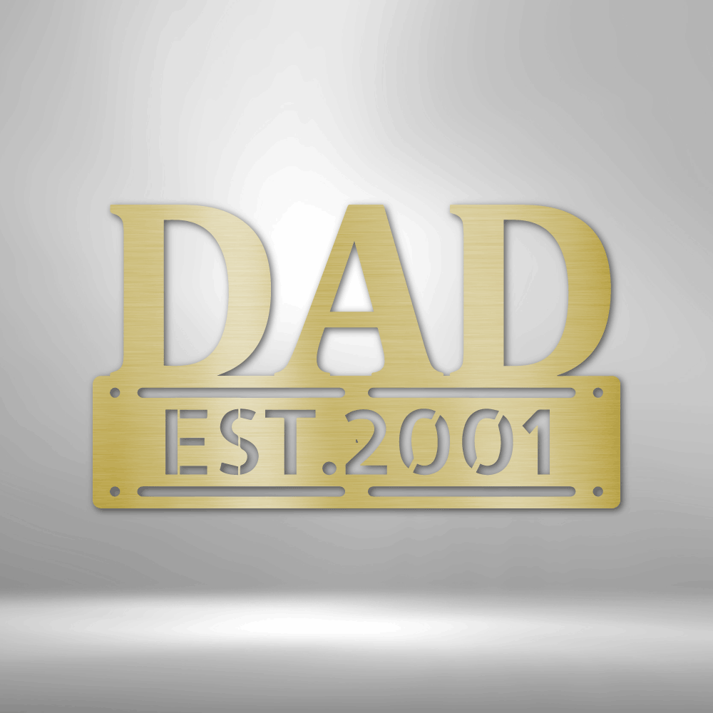 Personalized metal wall art sign of the word DAD in bold writing. You can personalize the row underneath it with a name or date. Use this as a gift for Father's Day. This picture shows the design in the color gold
