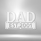 Personalized metal wall art sign of the word DAD in bold writing. You can personalize the row underneath it with a name or date. Use this as a gift for Father's Day. This picture shows the design in the color white