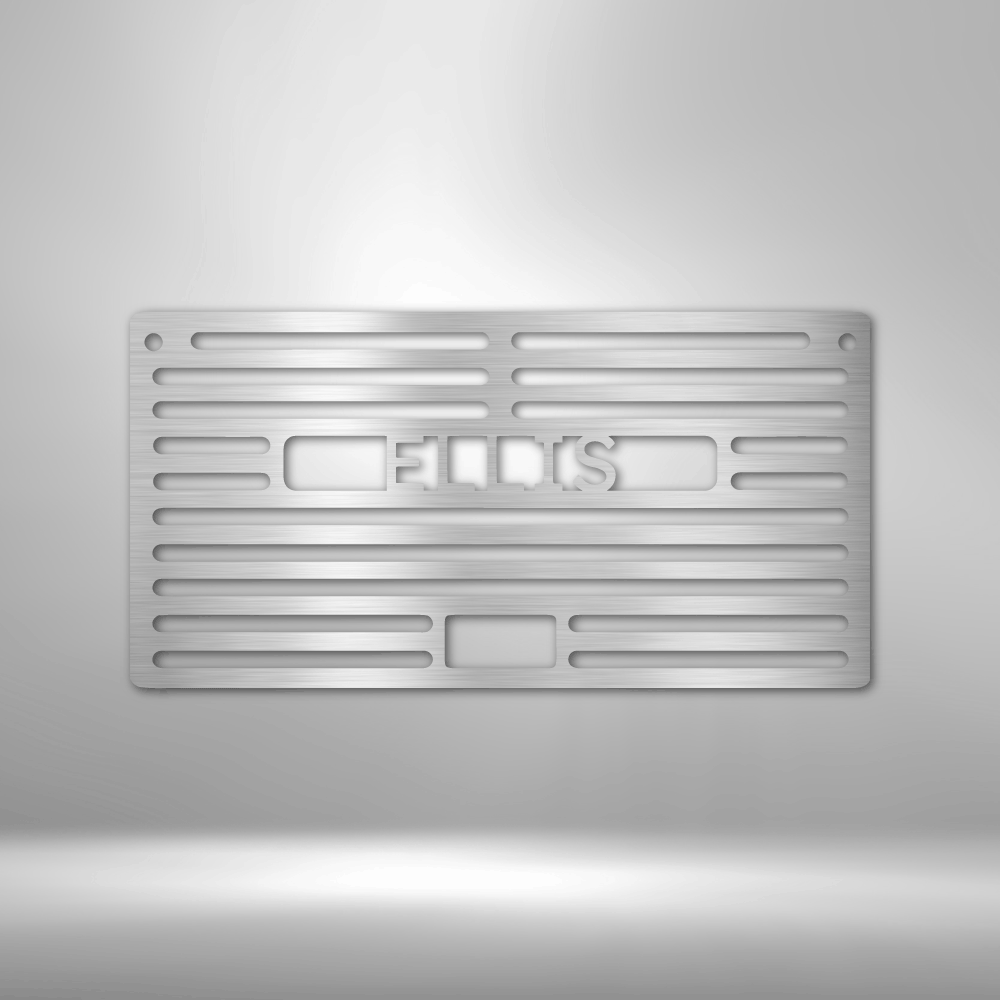 This picture show a metal silver colored campfire grill with a custom name inside the design