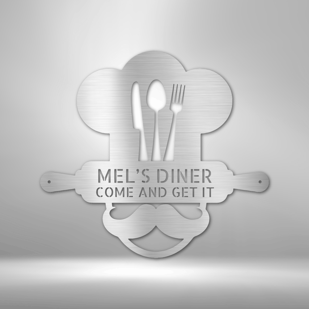 Metal Wall Art Sign of A Cooking chef with a chef's hat and a rolling pin that you can personalize with your own custom text or names. Hanging on the wall . It has the color silver