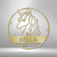 Metal wall art sign of a unicorn with a customized name on it, hanging on the wall. This picture shows the design in the color gold