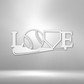 Metal wall art sign with a sport baseball theme. Hang this design on your bedroom wall or in your man cave. This design shows a baseball bat, baseball ball and an home plate, it spells out the word Love. This picture shows the sign in the color white