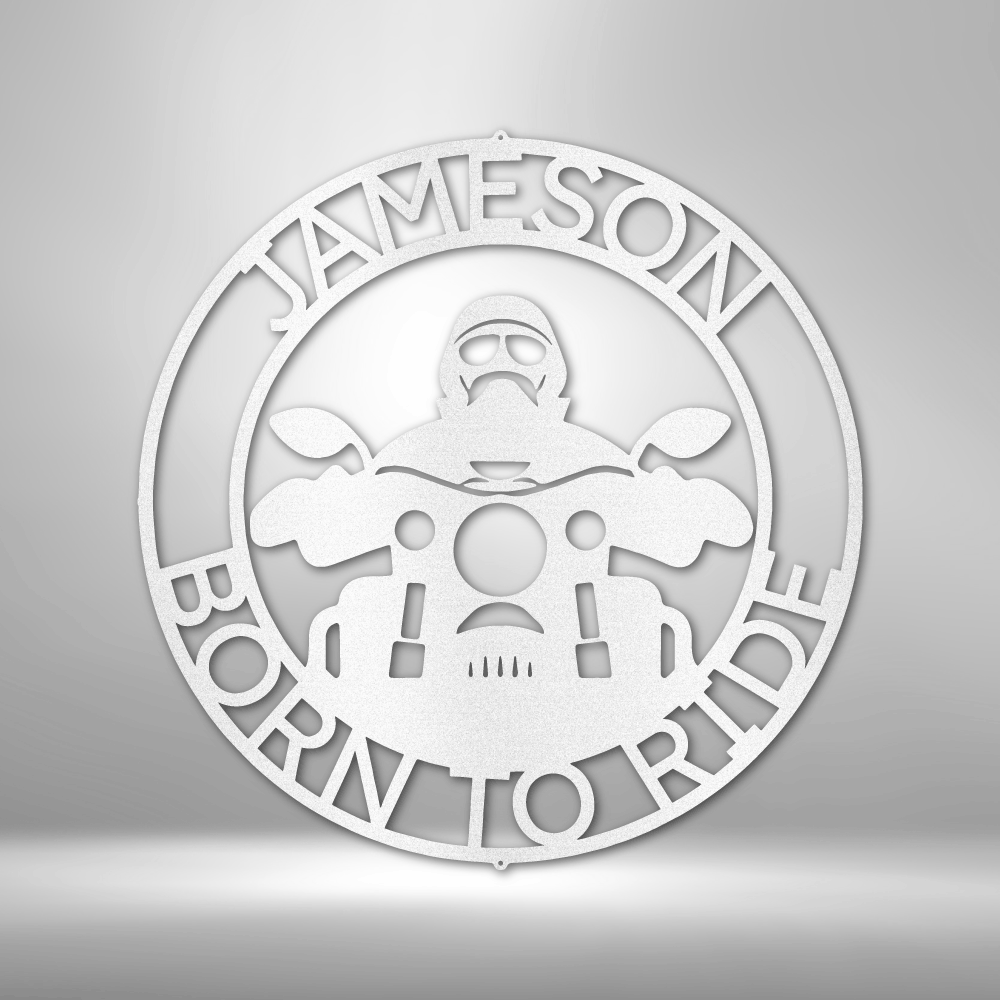 Metal Wall Art sign of a biker on a motorcycle with the text born to ride with a custom name. Personalize this home decor piece as a gift. This picture shows the design in the color white