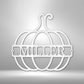 Outline of a pumpkin with a name inside of it as a metal wall art piece in the color white