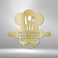 Metal Wall Art Sign of A Cooking chef with a chef's hat and a rolling pin that you can personalize with your own custom text or names. Hanging on the wall . It has the color gold