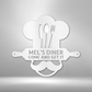 Metal Wall Art Sign of A Cooking chef with a chef's hat and a rolling pin that you can personalize with your own custom text or names. Hanging on the wall . It has the color white.