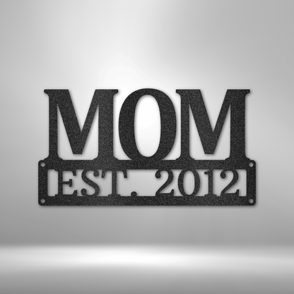 Metal Steel Sign with big letters MOM and underneath it is possible to add a custom text or name. The steel sign is hanging on the wall in the color black