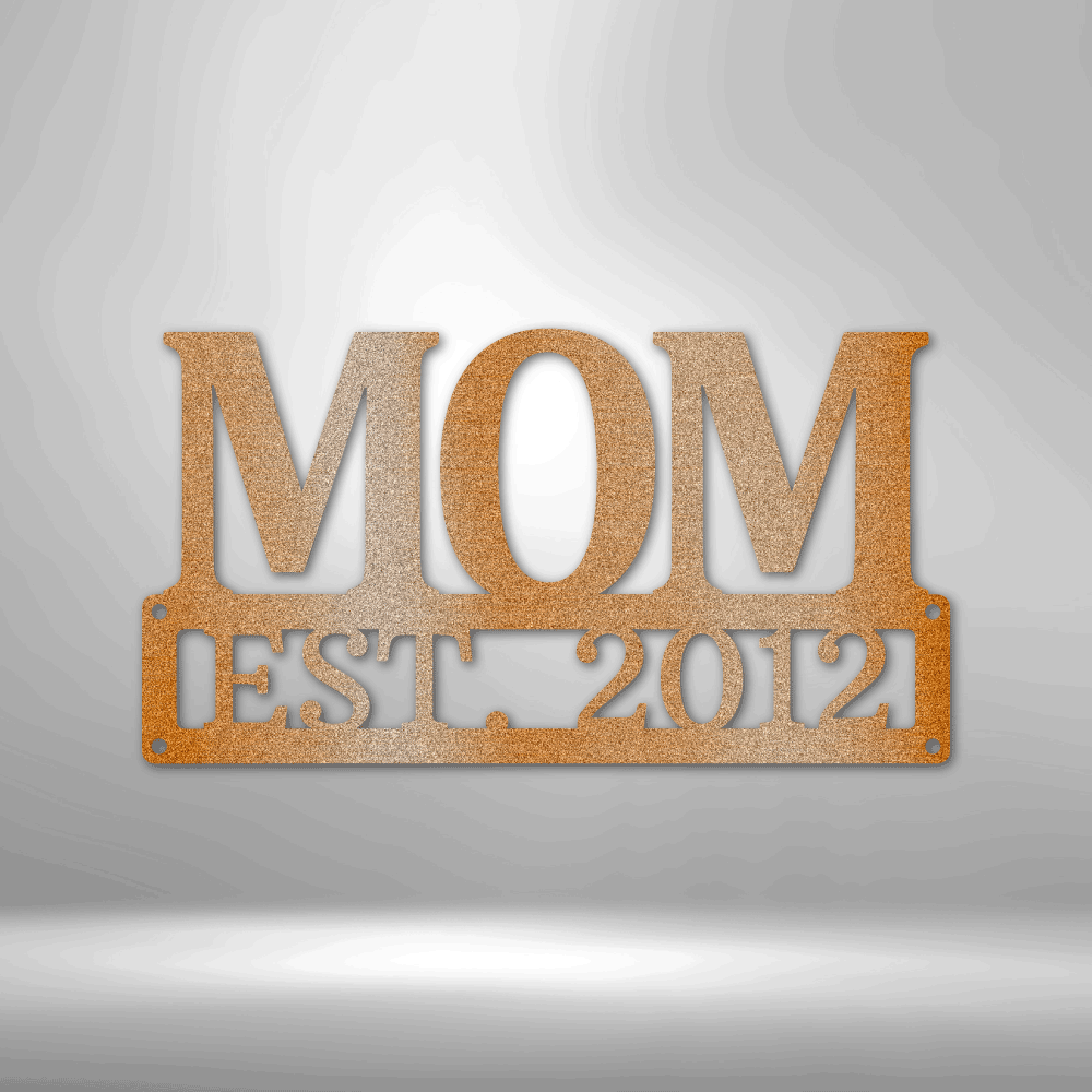 Metal Steel Sign with big letters MOM and underneath it is possible to add a custom text or name. The steel sign is hanging on the wall in the color copper