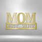 Metal Steel Sign with big letters MOM and underneath it is possible to add a custom text or name. The steel sign is hanging on the wall in the color gold