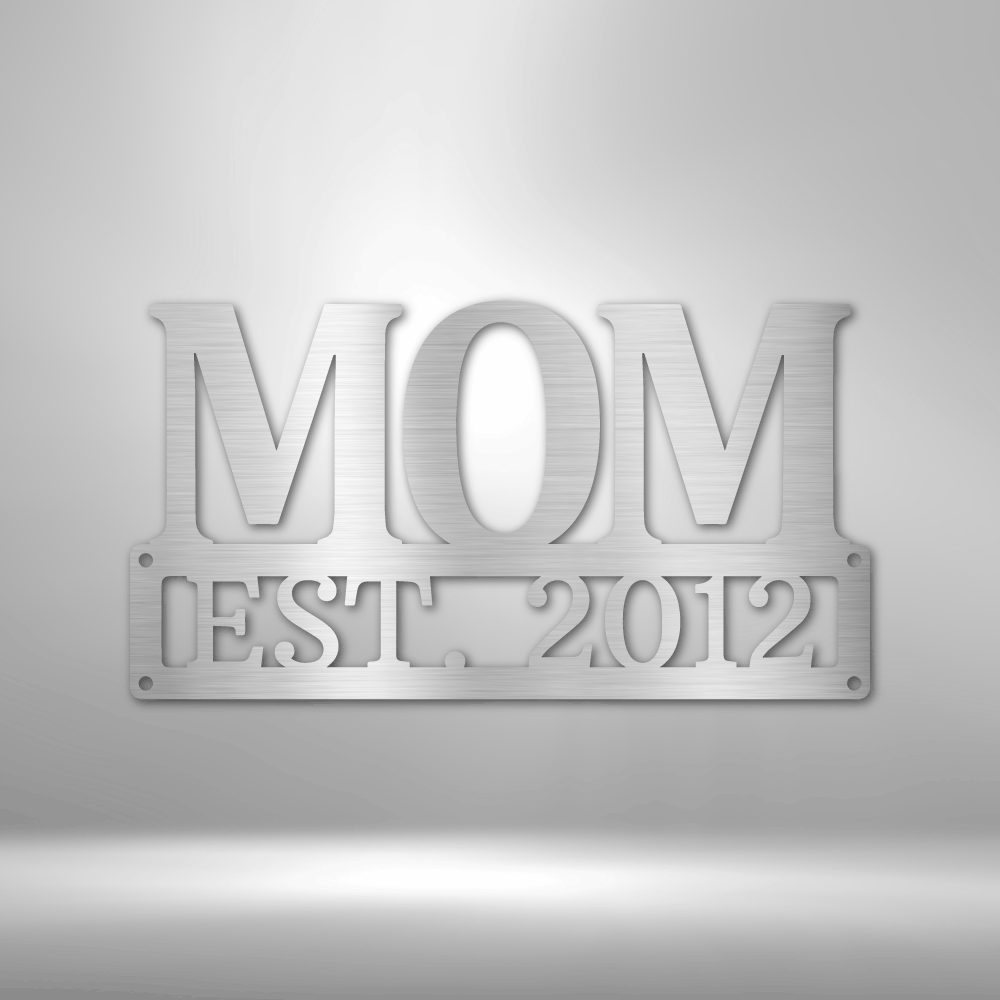 Metal Steel Sign with big letters MOM and underneath it is possible to add a custom text or name. The steel sign is hanging on the wall in the color silver