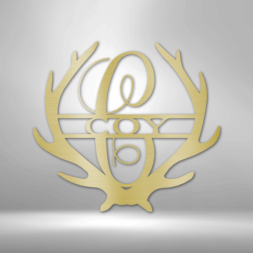 Metal Wall Art Sign of two antlers with a monogram and name inside in the color gold